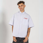 Unisex button-up shirt with a boxy fit and midi crop, featuring sailor stripes in ocean blue and white. Embroidered "Humble State of Mind" logo in burgundy red on the back and "Originals" embroidery on the front. Made from 100% thick cotton for a relaxed, summery style.