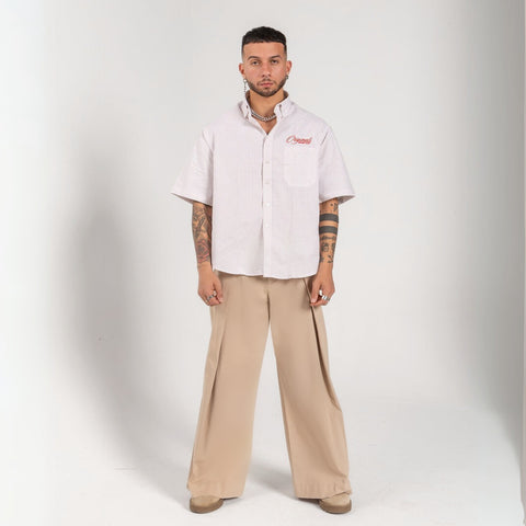 Unisex button-up shirt with a boxy fit and midi crop, featuring sailor stripes in sand beige and white. Embroidered "Humble State of Mind" logo in burgundy red on the back and "Originals" embroidery on the front. Made from 100% thick cotton for a relaxed, summery style.