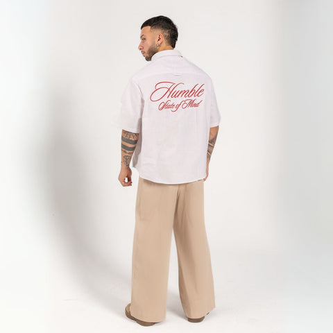 Unisex button-up shirt with a boxy fit and midi crop, featuring sailor stripes in sand beige and white. Embroidered "Humble State of Mind" logo in burgundy red on the back and "Originals" embroidery on the front. Made from 100% thick cotton for a relaxed, summery style.