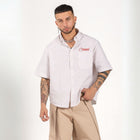 Unisex button-up shirt with a boxy fit and midi crop, featuring sailor stripes in sand beige and white. Embroidered "Humble State of Mind" logo in burgundy red on the back and "Originals" embroidery on the front. Made from 100% thick cotton for a relaxed, summery style.