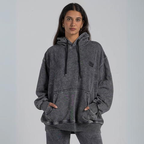 Model wearing the BROWNTOAST ASSID Hoodie in Charcoal Grey — unisex cotton-blend hoodie with relaxed fit and unique dye variations acid washed/stone washed. Each piece from the ASSID drop is one of a kind, made in Egypt through a special process for an elevated everyday look.