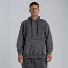 Model wearing the BROWNTOAST ASSID Hoodie in Charcoal Grey — unisex cotton-blend hoodie with relaxed fit and unique dye variations acid washed/stone washed. Each piece from the ASSID drop is one of a kind, made in Egypt through a special process for an elevated everyday look.