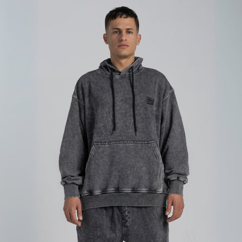 Model wearing the BROWNTOAST ASSID Hoodie in Charcoal Grey — unisex cotton-blend hoodie with relaxed fit and unique dye variations acid washed/stone washed. Each piece from the ASSID drop is one of a kind, made in Egypt through a special process for an elevated everyday look.