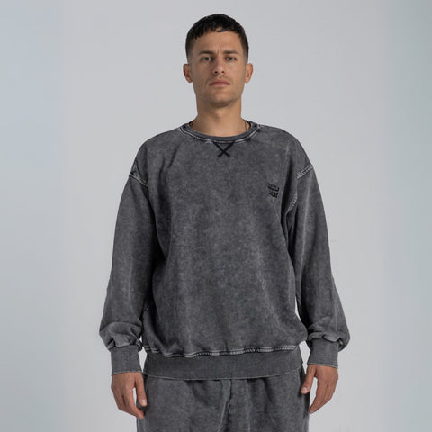 Model wearing the BROWNTOAST ASSID Crewneck Sweatshirt from the ASSID Collection — unisex cotton-blend crewneck with relaxed fit and unique acid stone wash dye variations. Made in Egypt, each piece is one of a kind, combining individuality and streetwear comfort.