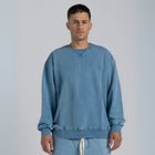 Model wearing the BROWNTOAST ASSID Crewneck Sweatshirt from the ASSID Collection — unisex cotton-blend crewneck with relaxed fit and unique acid stone wash dye variations. Made in Egypt, each piece is one of a kind, combining individuality and streetwear comfort.