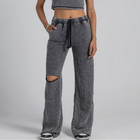 Model wearing the BROWNTOAST ASSID Women’s Sweatpants from the ASSID Kollection — relaxed-fit cotton-blend sweatpants with a ripped knee detail, adjustable waist, and unique dye variations. Made in Egypt for a lived-in, one-of-a-kind streetwear look.