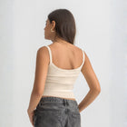 Beige ribbed spaghetti tank styled with denim jeans for a casual everyday outfit.