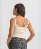 Beige ribbed spaghetti tank styled with denim jeans for a casual everyday outfit.