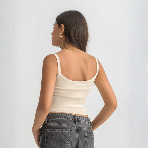 Beige ribbed spaghetti tank styled with denim jeans for a casual everyday outfit.