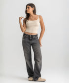 Beige ribbed spaghetti tank styled with denim jeans for a casual everyday outfit.