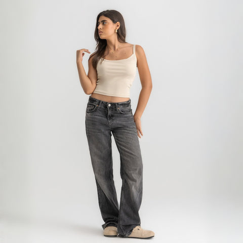 Beige ribbed spaghetti tank styled with denim jeans for a casual everyday outfit.