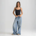 Black ribbed spaghetti tank styled with denim jeans for a casual everyday outfit.