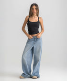 Black ribbed spaghetti tank styled with denim jeans for a casual everyday outfit.