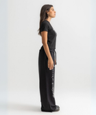 Women’s cropped black baby tee in cotton-lycra with faded grey Breakdown of Systems chest print.