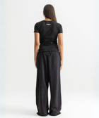 Women’s cropped black baby tee in cotton-lycra with faded grey Breakdown of Systems chest print.