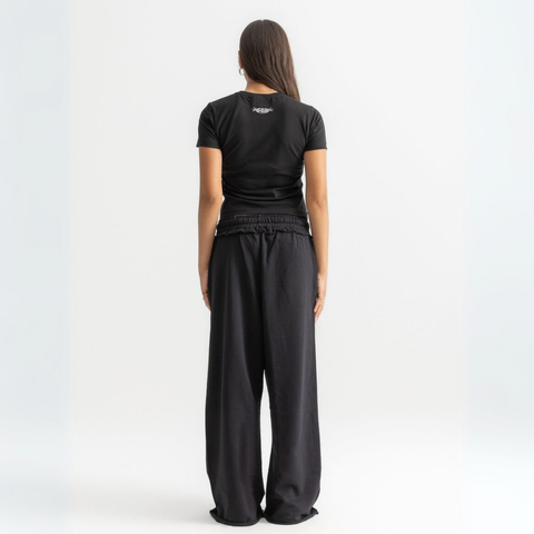 Women’s cropped black baby tee in cotton-lycra with faded grey Breakdown of Systems chest print.