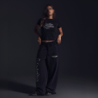 Women’s cropped black baby tee in cotton-lycra with faded grey Breakdown of Systems chest print.