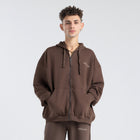 Model wearing the BROWNTOAST Core Full Zip Up Jacket from the Core Drop — a relaxed unisex hoodie with a dual zipper and adjustable hood. Made in Egypt from soft cotton, combining everyday comfort with effortless street style.