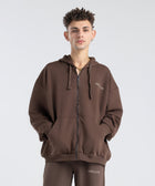 Model wearing the BROWNTOAST Core Full Zip Up Jacket from the Core Drop — a relaxed unisex hoodie with a dual zipper and adjustable hood. Made in Egypt from soft cotton, combining everyday comfort with effortless street style.