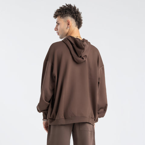 Model wearing the BROWNTOAST Core Full Zip Up Jacket from the Core Drop — a relaxed unisex hoodie with a dual zipper and adjustable hood. Made in Egypt from soft cotton, combining everyday comfort with effortless street style.