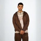 Model wearing the BROWNTOAST Core Full Zip Up Jacket from the Core Drop — a relaxed unisex hoodie with a dual zipper and adjustable hood. Made in Egypt from soft cotton, combining everyday comfort with effortless street style.