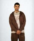 Model wearing the BROWNTOAST Core Full Zip Up Jacket from the Core Drop — a relaxed unisex hoodie with a dual zipper and adjustable hood. Made in Egypt from soft cotton, combining everyday comfort with effortless street style.