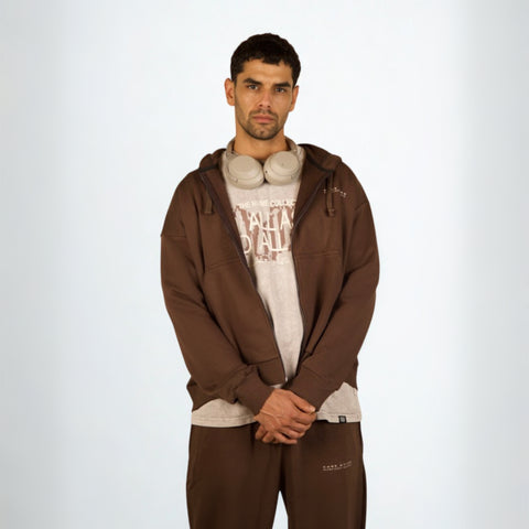 Model wearing the BROWNTOAST Core Full Zip Up Jacket from the Core Drop — a relaxed unisex hoodie with a dual zipper and adjustable hood. Made in Egypt from soft cotton, combining everyday comfort with effortless street style.
