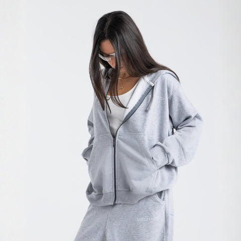 Model wearing the BROWNTOAST Core Full Zip Up Jacket from the Core Drop — a relaxed unisex hoodie with a dual zipper and adjustable hood. Made in Egypt from soft cotton, combining everyday comfort with effortless street style.