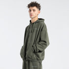  Model wearing the BROWNTOAST Core Full Zip Up Jacket from the Core Drop — a relaxed unisex hoodie with a dual zipper and adjustable hood. Made in Egypt from soft cotton, combining everyday comfort with effortless street style.