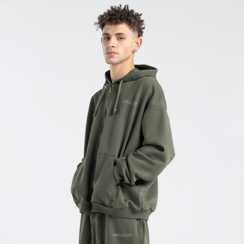  Model wearing the BROWNTOAST Core Full Zip Up Jacket from the Core Drop — a relaxed unisex hoodie with a dual zipper and adjustable hood. Made in Egypt from soft cotton, combining everyday comfort with effortless street style.