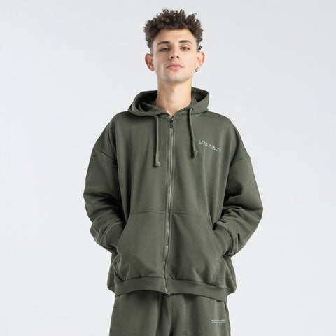 Model wearing the BROWNTOAST Core Full Zip Up Jacket from the Core Drop — a relaxed unisex hoodie with a dual zipper and adjustable hood. Made in Egypt from soft cotton, combining everyday comfort with effortless street style.