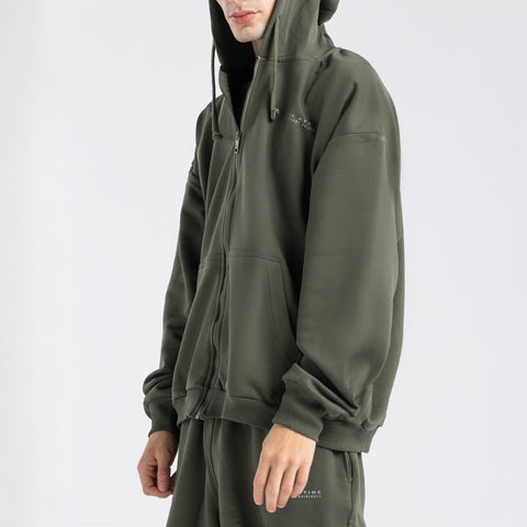 Model wearing the BROWNTOAST Core Full Zip Up Jacket from the Core Drop — a relaxed unisex hoodie with a dual zipper and adjustable hood. Made in Egypt from soft cotton, combining everyday comfort with effortless street style.