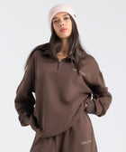 Core Quarter Zip Up sweatshirt in brown, front view showcasing relaxed boxy fit and minimal design.