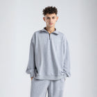 Core Quarter Zip Up sweatshirt in light grey, front view showcasing relaxed boxy fit and minimal design.