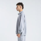 Core Quarter Zip Up sweatshirt in light grey, front view showcasing relaxed boxy fit and minimal design.