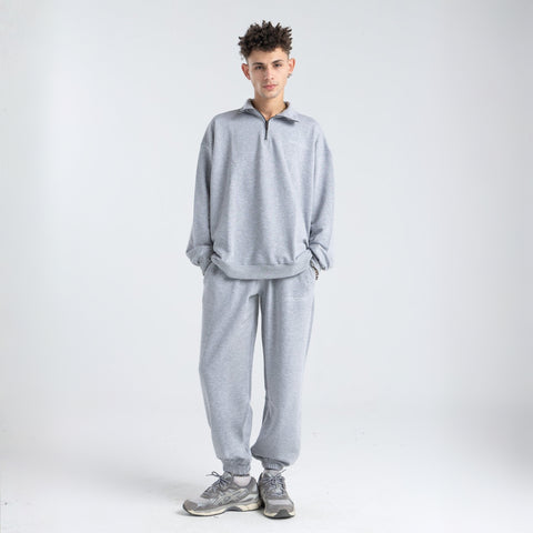 Core Quarter Zip Up sweatshirt in light grey, front view showcasing relaxed boxy fit and minimal design.