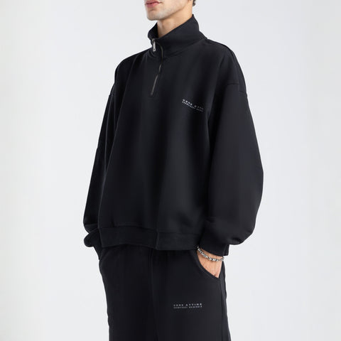 Core Quarter Zip Up sweatshirt in black, front view showcasing relaxed boxy fit and minimal design.