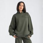 Core Quarter Zip Up sweatshirt in olive, front view showcasing relaxed boxy fit and minimal design.