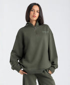 Core Quarter Zip Up sweatshirt in olive, front view showcasing relaxed boxy fit and minimal design.