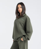 Core Quarter Zip Up sweatshirt in olive, front view showcasing relaxed boxy fit and minimal design.