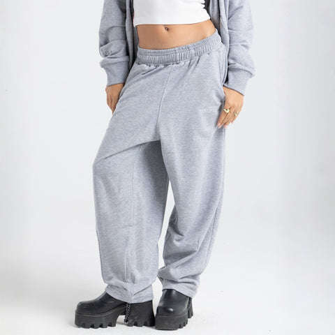 Model wearing the BROWNTOAST Core Barrel Sweats from the Core Drop — unisex cotton sweatpants in light grey with a relaxed barrel-shaped leg, elastic waistband, and side pockets. Made in Egypt for structured comfort and clean everyday style.