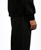 Model wearing the BROWNTOAST Core Barrel Sweats from the Core Drop — unisex cotton sweatpants in black with a relaxed barrel-shaped leg, elastic waistband, and side pockets. Made in Egypt for structured comfort and clean everyday style.