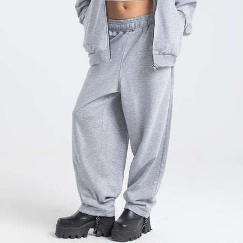 Model wearing the BROWNTOAST Core Barrel Sweats from the Core Drop — unisex cotton sweatpants in light grey with a relaxed barrel-shaped leg, elastic waistband, and side pockets. Made in Egypt for structured comfort and clean everyday style.