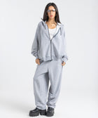Model wearing the BROWNTOAST Core Barrel Sweats from the Core Drop — unisex cotton sweatpants in light grey with a relaxed barrel-shaped leg, elastic waistband, and side pockets. Made in Egypt for structured comfort and clean everyday style.