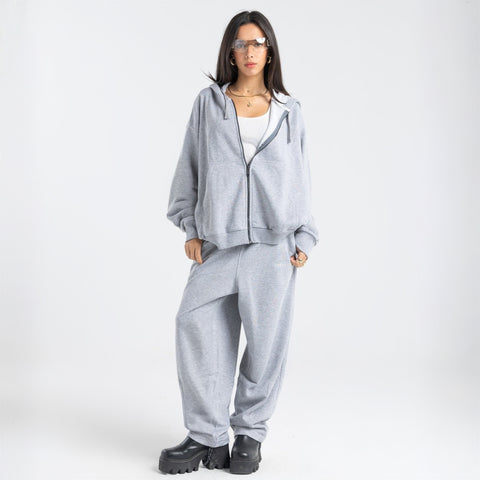 Model wearing the BROWNTOAST Core Barrel Sweats from the Core Drop — unisex cotton sweatpants in light grey with a relaxed barrel-shaped leg, elastic waistband, and side pockets. Made in Egypt for structured comfort and clean everyday style.
