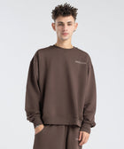 Model wearing the BROWNTOAST Core Crewneck from the Core Drop — a relaxed unisex sweatshirt with a classic crew neckline and front silk-screen print. Made in Egypt from a soft cotton-lycra blend for elevated everyday comfort and style.