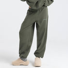 Model wearing the BROWNTOAST Core Cuffed Sweats from the Core Drop in olive green — unisex cotton sweatpants with cuffed ankles, adjustable drawstring waist, and side pockets. Made in Egypt for a relaxed, structured, and effortless everyday fit.