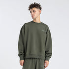 Model wearing the BROWNTOAST Core Crewneck from the Core Drop — a relaxed unisex sweatshirt with a classic crew neckline and front silk-screen print. Made in Egypt from a soft cotton-lycra blend for elevated everyday comfort and style.