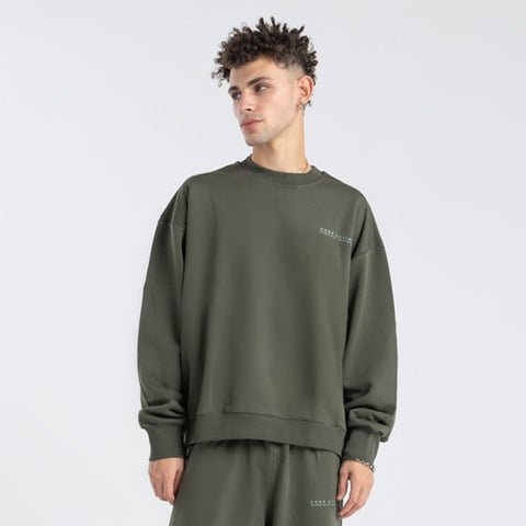 Model wearing the BROWNTOAST Core Crewneck from the Core Drop — a relaxed unisex sweatshirt with a classic crew neckline and front silk-screen print. Made in Egypt from a soft cotton-lycra blend for elevated everyday comfort and style.