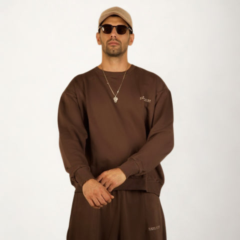 Model wearing the BROWNTOAST Core Crewneck from the Core Drop — a relaxed unisex sweatshirt with a classic crew neckline and front silk-screen print. Made in Egypt from a soft cotton-lycra blend for elevated everyday comfort and style.